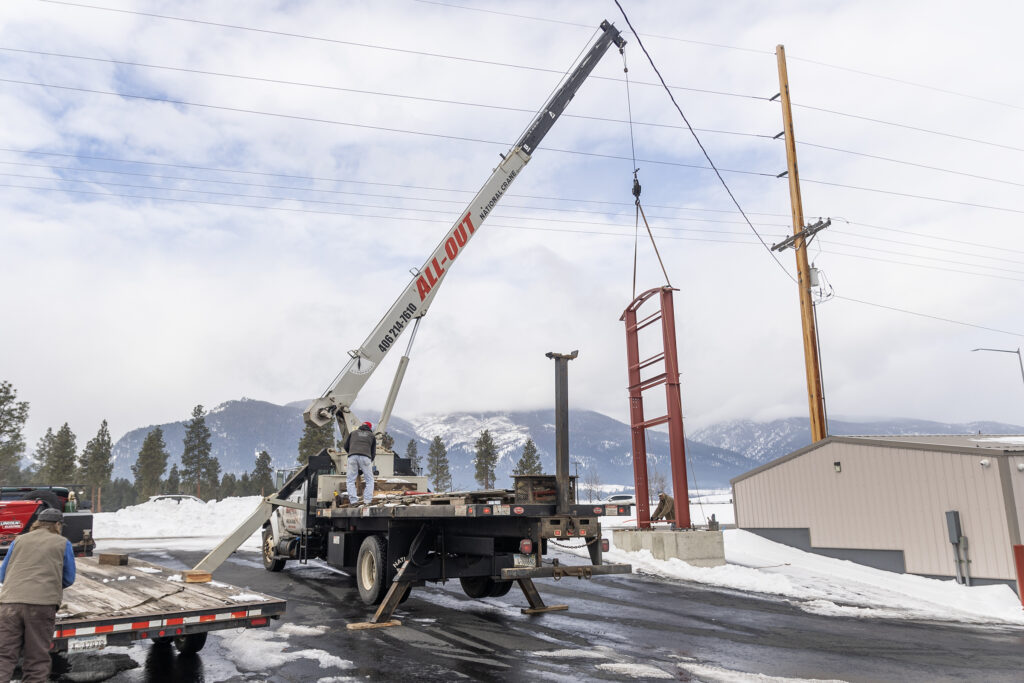 The sign post being put into position by the crane.